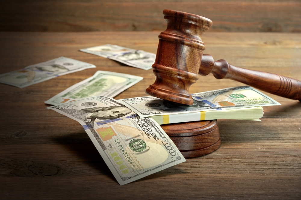 Money on top of gavel on the desk of an Alimony Lawyer Kansas City, KS
